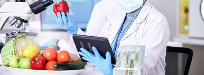 A person in a laboratory testing food